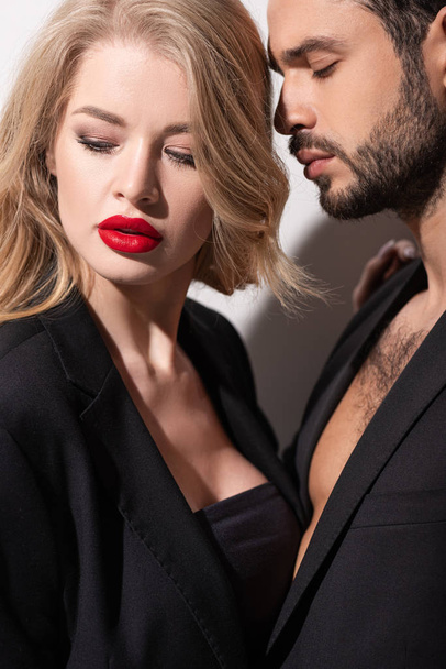bearded man near attractive and young woman with red lips on white  - Photo, Image