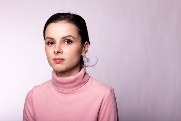 beautiful girl in a pink turtleneck on a gray background - Photo, Image