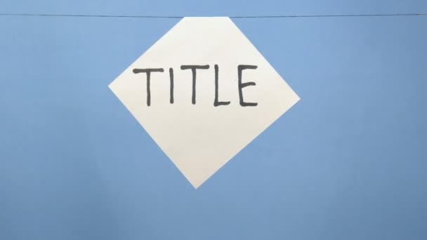 Горящий и дымящийся белый лист бумаги с черной надписью "title" на синем фоне
 - Кадры, видео