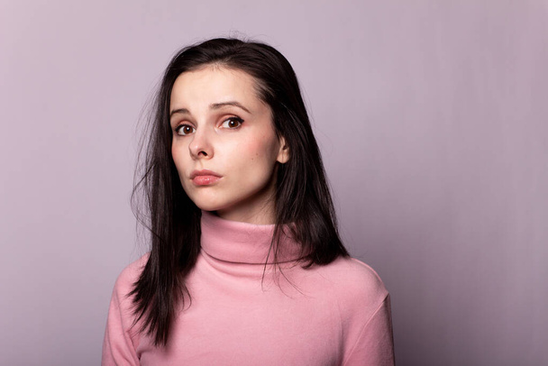 beautiful girl in a pink turtleneck on a gray background - Photo, Image