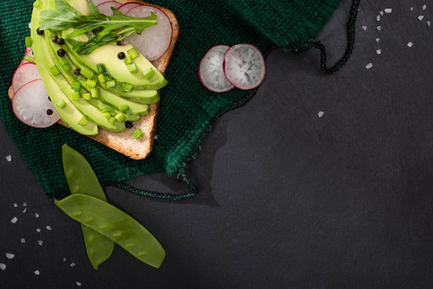 top view of toast with avocado and leek and radish on cloth - Photo, Image