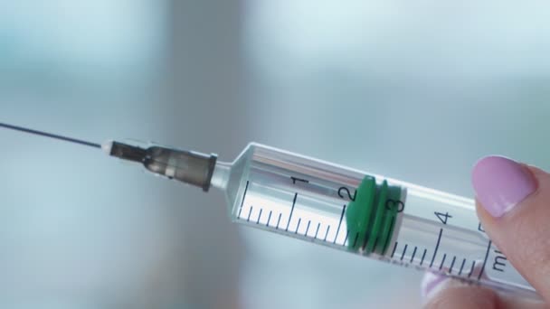 Close-up shot of syringe during injection, drug addiction problem, aids epidemic, vaccination. Medicine liquid delivering to patient body - Materiaali, video