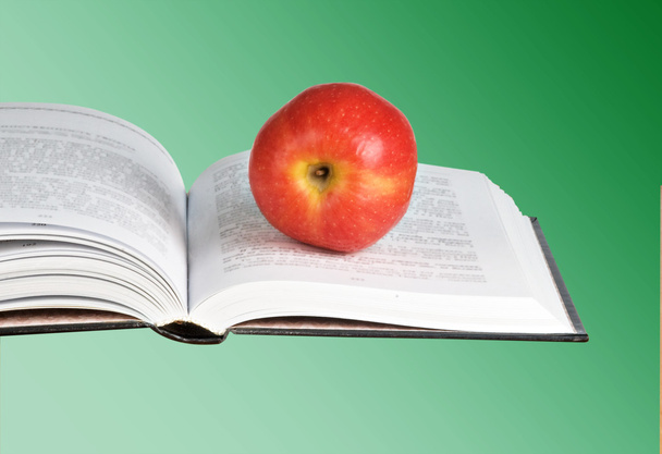 червоне яблуко на відкритій книзі
 - Фото, зображення