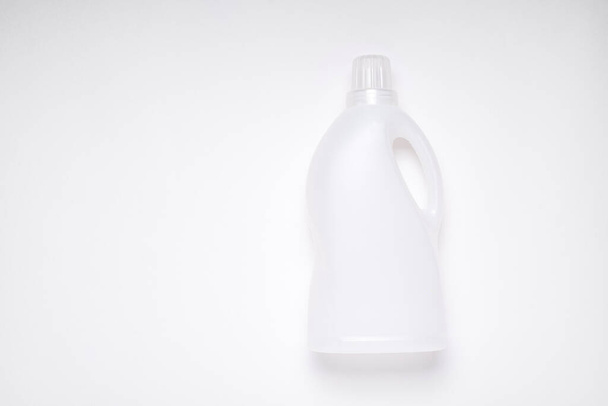 bovenaanzicht witte lege plastic reinigingsproduct fles op witte achtergrond met kopieerruimte voor branding - Foto, afbeelding