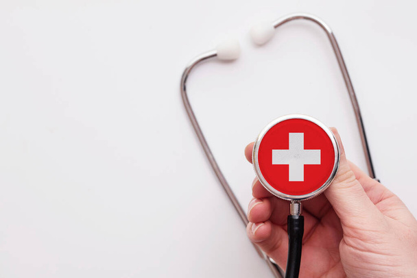 Switzerland healthcare concept. Doctor holding a medical stethoscope. - Foto, imagen