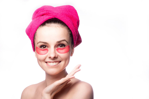 young woman after a shower in a pink towel and patches - Foto, Imagen