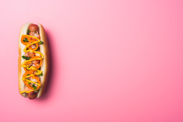 top view of tasty hot dog on pink with copy space - Foto, Imagem