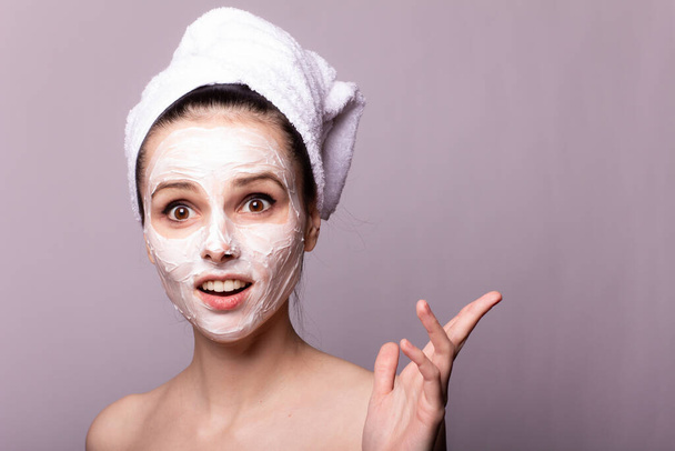 girl in a white towel on her head with a mask on her face - Photo, Image