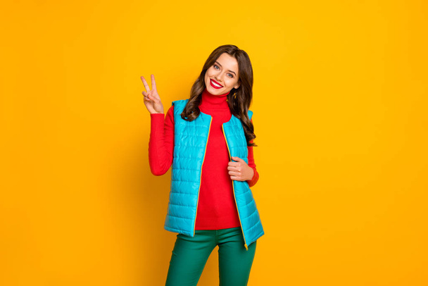 Portrait of satisfied dream dreamy girl enjoy spring weekend holiday make v-sign wear vivid pants isolated over bright color background - Foto, immagini