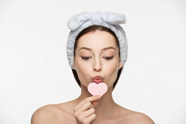attractive girl kissing heart-shaped cosmetic sponge isolated on white - Fotografie, Obrázek