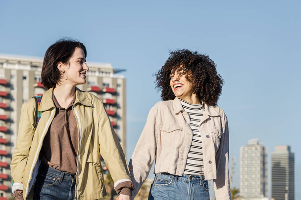 couple of women chatting and walking at the city - Valokuva, kuva