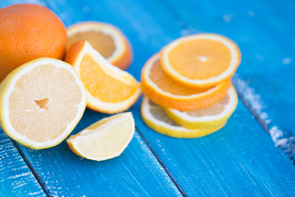 citrus fruits  orange and lemons on blue background - Photo, Image