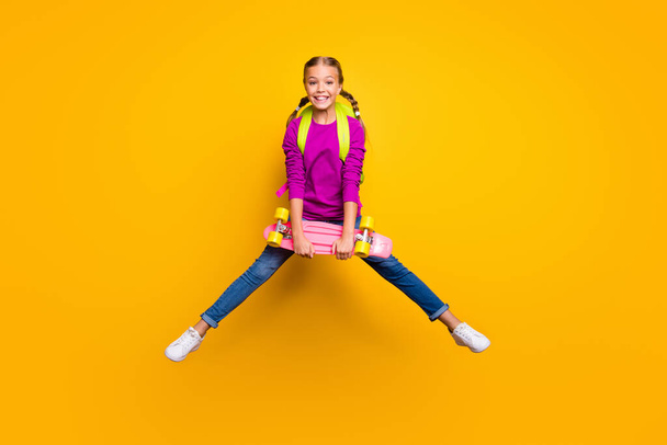 Full length body size view of her she nice attractive glad cheerful cheery girl jumping carrying longboard pass exam test isolated on bright vivid shine vibrant yellow color background - 写真・画像
