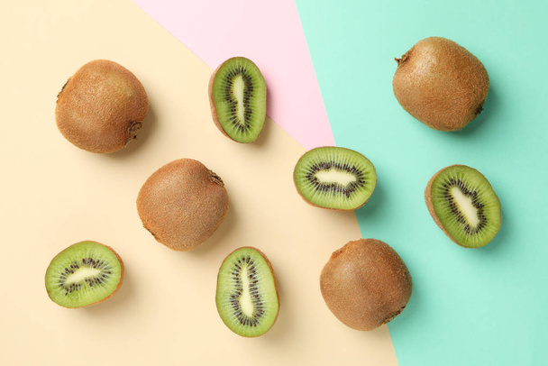 Ripe sweet kiwi on multicolor background, top view - Photo, Image