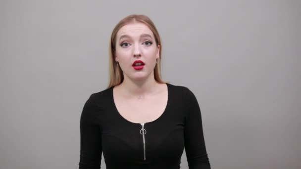 Jeune fille blonde en veste noire femme choquée tient ses mains sur ses joues
 - Séquence, vidéo