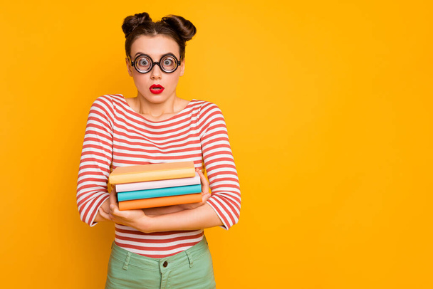 Photo of pretty lady student look through circle freak specs open mouth have to study all night hold books wear striped red white shirt isolated bright yellow color background - Fotografie, Obrázek