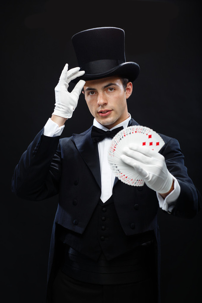 Magician showing trick with playing cards - Photo, image