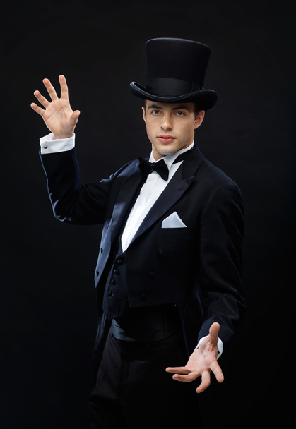 Magician in top hat showing trick - 写真・画像