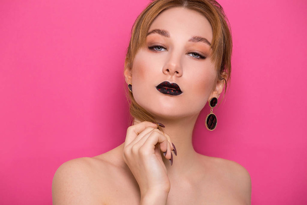 A beautiful young girl of European appearance with beautiful make-up on a pink background. Beauty Shooting - Foto, Bild