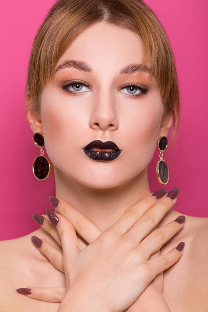A beautiful young girl of European appearance with beautiful make-up on a pink background. Beauty Shooting - Fotoğraf, Görsel