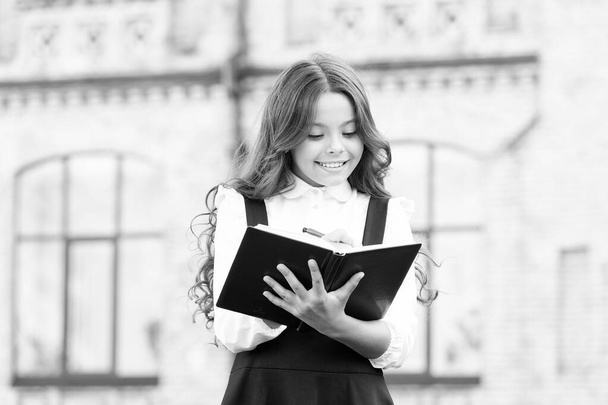 Intellectual task. Cognitive process. Start new school project. Welcome back to school. School girl formal uniform hold book. Towards knowledge. Students life. School student. Intelligent child - Фото, зображення