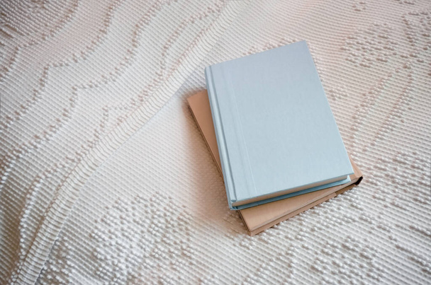 Two Plain Hardcover Books Stacked on a Bed - Foto, immagini