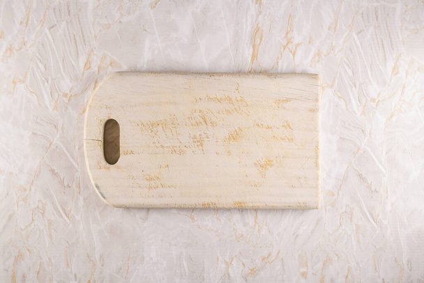 Wooden cutting board on a gray marble background - Φωτογραφία, εικόνα