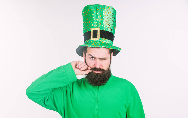 He twirling his moustache around his finger. Irish man with beard wearing green. Happy saint patricks day. Hipster in leprechaun hat and costume. Bearded man celebrating saint patricks day - Фото, изображение