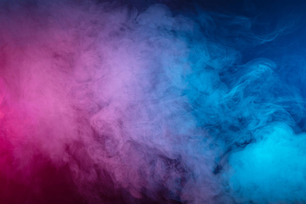 pink cloud of smoke of  black isolated background. Background from the smoke of vap - Foto, imagen
