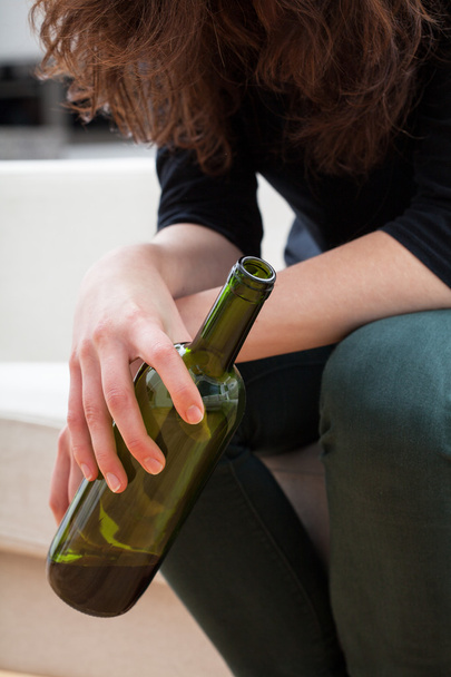 Woman holding a bottle of wine - Фото, изображение