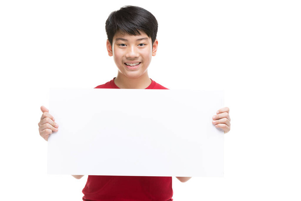 Boy holds blank sign. Teen boy holds empty billboard. - Valokuva, kuva