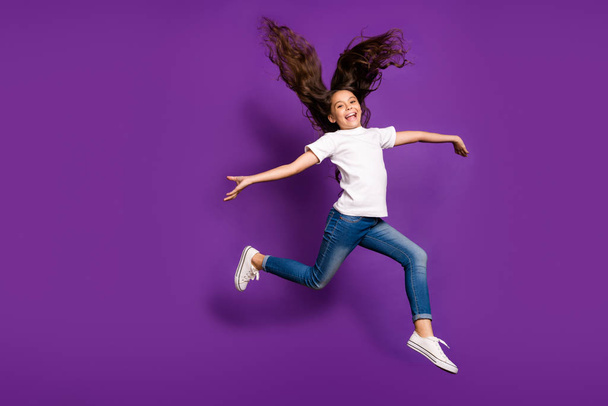 Full length body size view of her she nice attractive cheerful cheery wavy-haired girl jumping having fun running wind isolated on bright vivid shine vibrant purple violet lilac color background - Фото, изображение