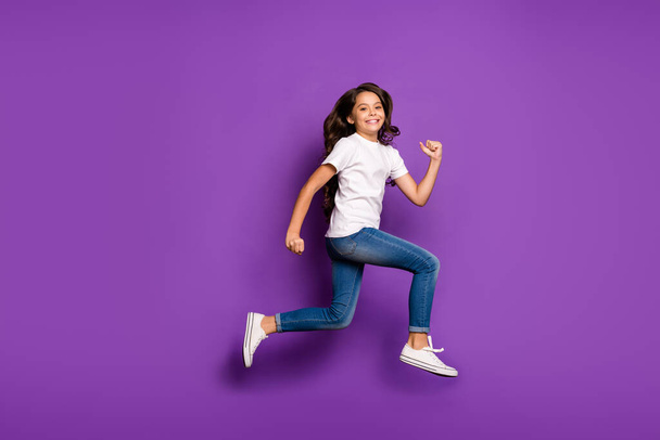 Full length body size view of her she nice attractive lovely cheerful cheery wavy-haired girl jumping running fast motion isolated on bright vivid shine vibrant purple violet lilac color background - Foto, immagini