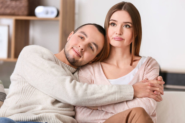 Beautiful young couple watching TV at home - Photo, Image