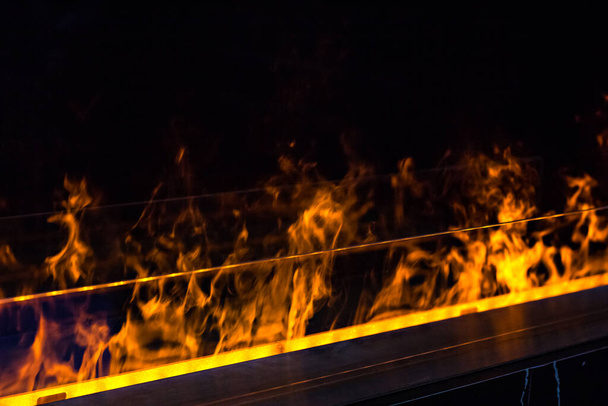 fire in a biofireplace.  Modern bio fireplot fireplace on ethanol gas. - Fotó, kép