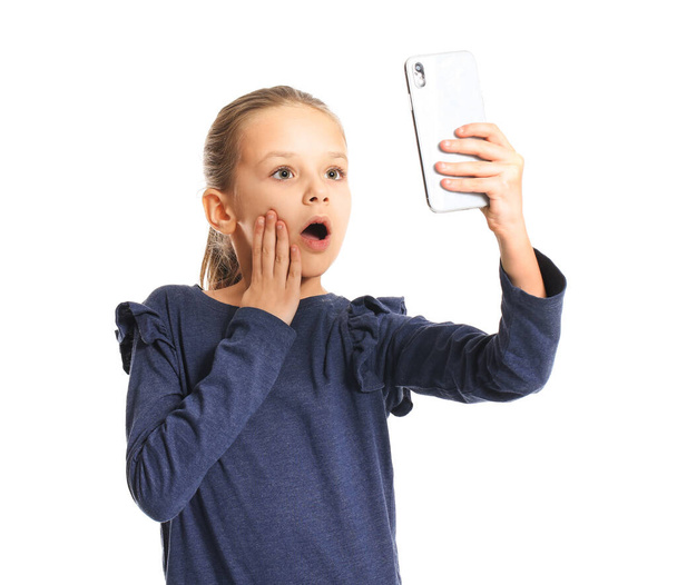 Cute little girl taking selfie on white background - Foto, Imagem