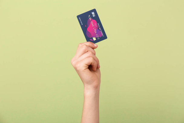 Női kéz hitelkártyával színes háttér - Fotó, kép