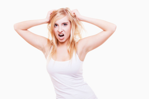 Le stress. Jeune femme frustrée tirant ses cheveux sur blanc - Photo, image
