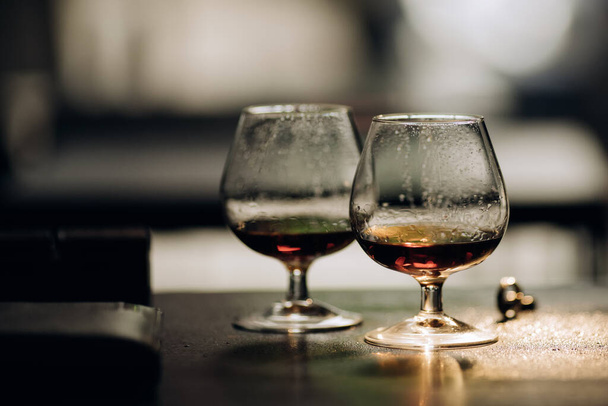 Two glasses with cognac on a dark background. Alcohol - Photo, image