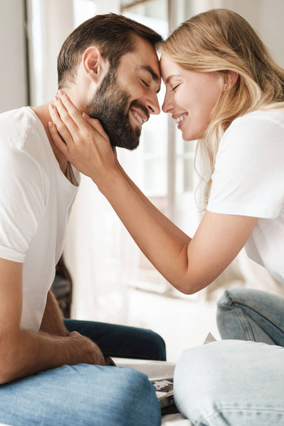 Positive loving couple indoors at home kissing. - Foto, Imagem