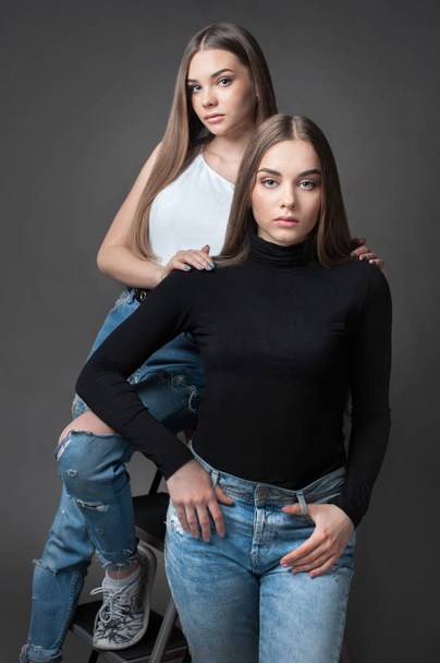 two sisters twins girl posing, dressed like Yin Yang black and white shirt - Foto, Imagem