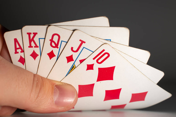 Kézben tartani egy nyerő sorsolást egy pókermeccsen. A legmagasabb kéz a pókerben. - Fotó, kép