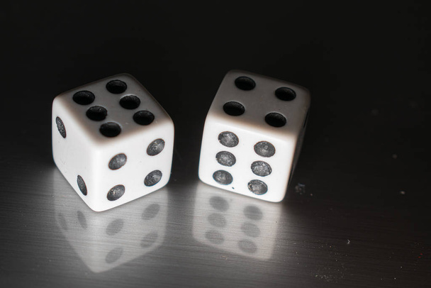 Closeup of a pair of dice on a reflective surface, with winning numbers and reflection bellow them. - Photo, Image