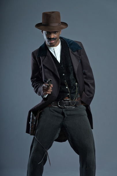 Shooting retro Afro america western cowboy man with mustache. We - 写真・画像