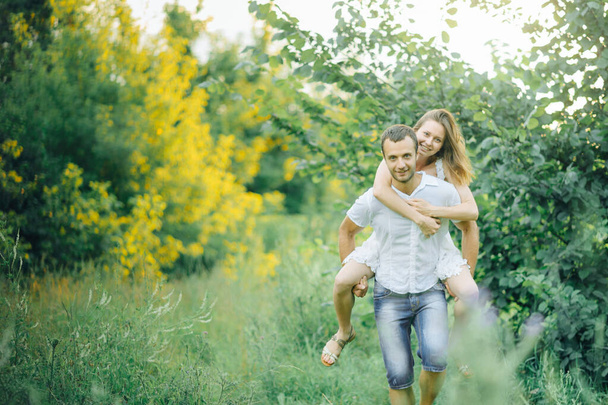 happy couple have fun in the park on nature. - 写真・画像