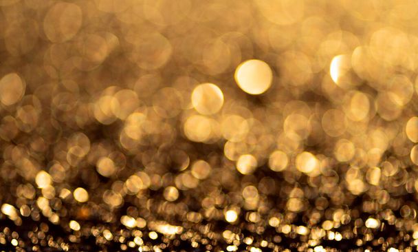Gold glitter particles background. Sparkling light boke blur. - Foto, Imagem