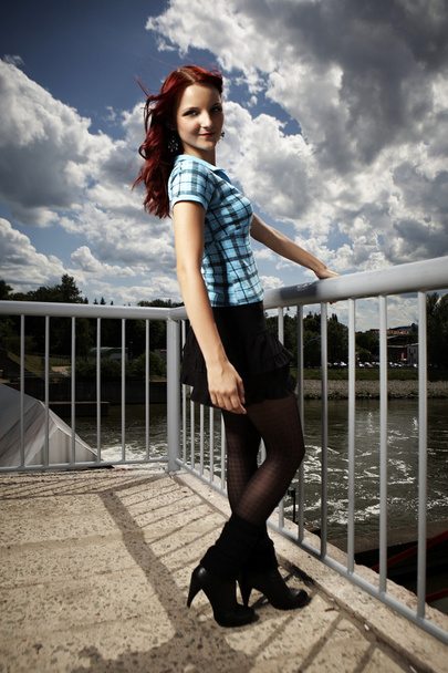 Girl posing in summer light on floodgate - Foto, afbeelding