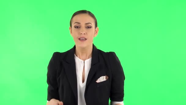 Displeased woman indignantly talking to someone, looking at the camera. Green screen - Video, Çekim