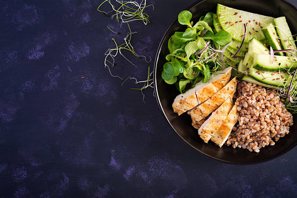 Lunch salad. Buddha bowl with buckwheat porridge, grilled chicken fillet, corn salad, microgreens and daikon. Healthy food. Top view, overhead - Photo, Image