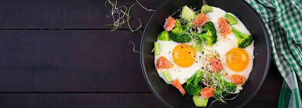 Ketogenic/paleo diet. Fried eggs, salmon, broccoli and microgreen.  Keto breakfast. Brunch.  Top view, banner - Foto, immagini